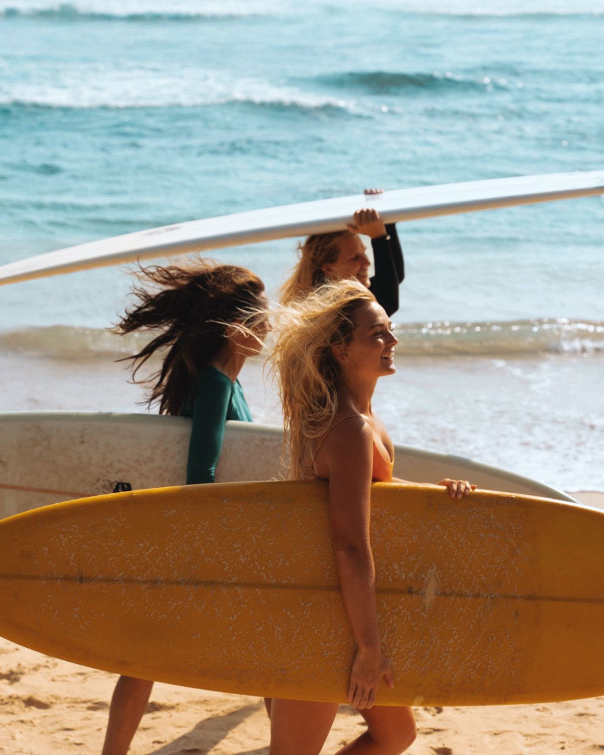Walking down to the break with boards under-arm